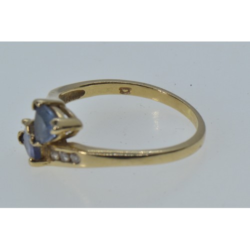 2 - 10ct gold crossover ring set with blue & clear stones, size N, 2 grams