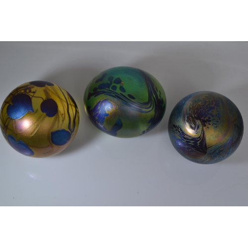 641 - Three John Ditchfield Glasform iridescent glass paperweights, including two spherical & one ovoi... 