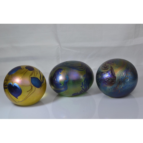 641 - Three John Ditchfield Glasform iridescent glass paperweights, including two spherical & one ovoi... 