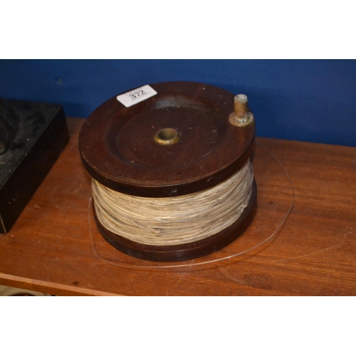 264 - Large wooden fishing reel and line, 18cm dia.