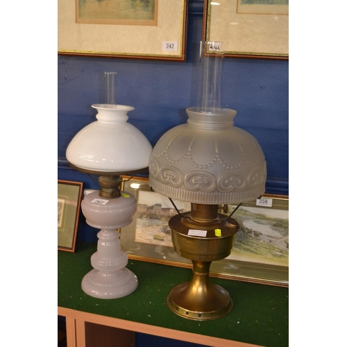 262 - Two oil lamps, one with glass base, the other metal, both with glass shades and flues, height of tal... 