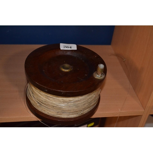 264 - Large wooden fishing reel and line, 18cm dia.