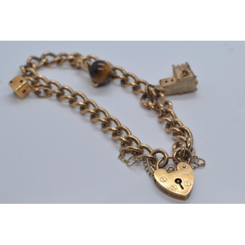 2 - 9ct gold charm bracelet with heart-shaped padlock clasp, with three charms, including church, di &am... 