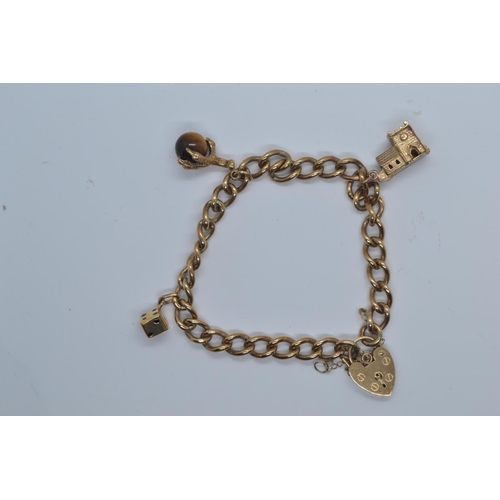 2 - 9ct gold charm bracelet with heart-shaped padlock clasp, with three charms, including church, di &am... 