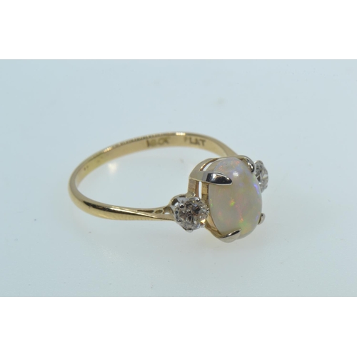 27 - 18ct gold ring with an oval cabochon opal in a yellow claw setting, flanked by round brilliant cut d... 