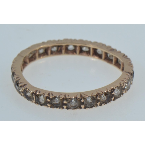 38 - Yellow metal & white stone eternity ring, tests positive for 9ct gold, size N1/2, 1.79 grams