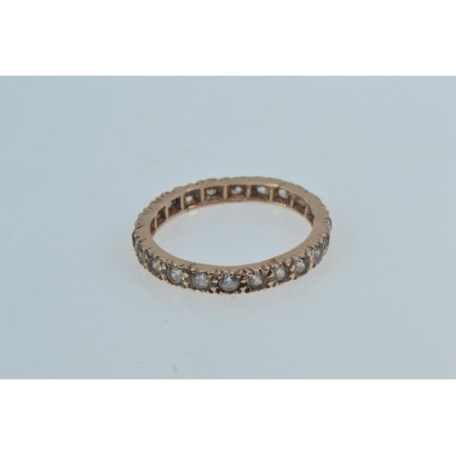 38 - Yellow metal & white stone eternity ring, tests positive for 9ct gold, size N1/2, 1.79 grams