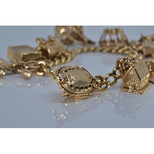 48 - 18ct gold charm bracelet suspending twelve 9ct gold charms, all charms stamped '9.375' except Scorpi... 