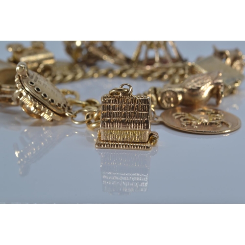 48 - 18ct gold charm bracelet suspending twelve 9ct gold charms, all charms stamped '9.375' except Scorpi... 