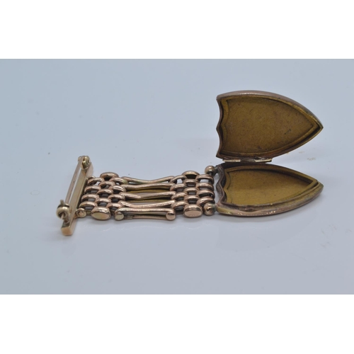 56 - 9ct gold back & front shield-shaped locket suspended from a yellow metal link brooch fitting, ye... 