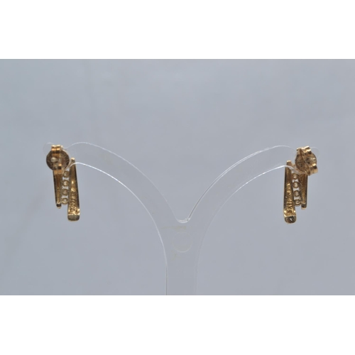 58 - Pair of 14ct gold & diamond earrings, length 16mm, post fittings, gross weight 2.05 grams