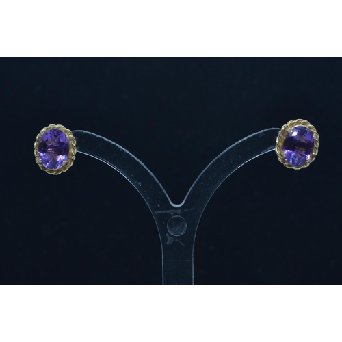 59 - Two pairs of 9ct gold ear studs, one set with amethyst, the other designed as a leaf, gross weight 2... 