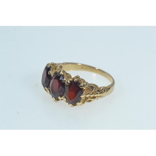 78 - 9ct gold & garnet trilogy ring, size K, 3.52 grams