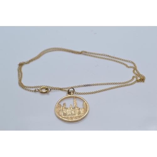 116 - 14ct gold pendant depicting New York skyline, with chain, pendant length including bale 28mm, chain ... 