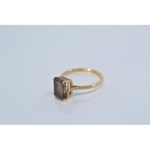 128 - 9ct gold ring set with baguette cut smoky quartz (8mm x 6mm) gross weight 2g. Size P