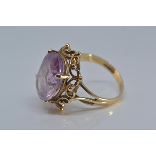 137 - 9ct gold ring set with single oval amethyst stone 15mm x 12mm, size O/P gross, weight 5.2 grams