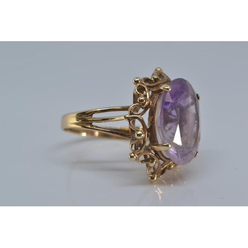 137 - 9ct gold ring set with single oval amethyst stone 15mm x 12mm, size O/P gross, weight 5.2 grams