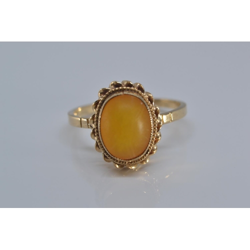 142 - 9ct gold ring bezel set with amber coloured stone size N/O gross weight 2grams