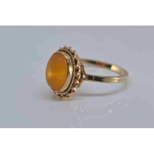 142 - 9ct gold ring bezel set with amber coloured stone size N/O gross weight 2grams