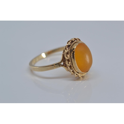 142 - 9ct gold ring bezel set with amber coloured stone size N/O gross weight 2grams