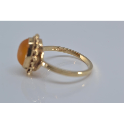 142 - 9ct gold ring bezel set with amber coloured stone size N/O gross weight 2grams