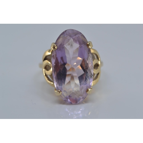 143 - 9ct gold ring claw-set with an oval amethyst 20 x 12mm, size N/O, gross weight 5.3 grams