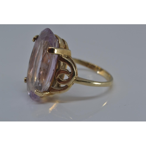 143 - 9ct gold ring claw-set with an oval amethyst 20 x 12mm, size N/O, gross weight 5.3 grams