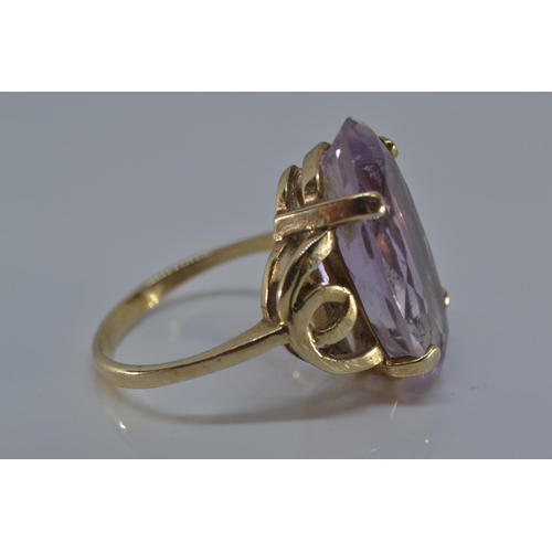 143 - 9ct gold ring claw-set with an oval amethyst 20 x 12mm, size N/O, gross weight 5.3 grams