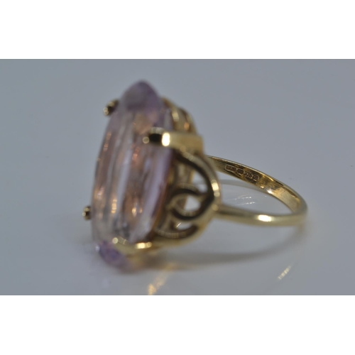 143 - 9ct gold ring claw-set with an oval amethyst 20 x 12mm, size N/O, gross weight 5.3 grams