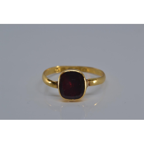 147 - 22ct gold ring with early Victorian hallmark, bezel-set with a red stone, size P, gross weight 2.1 g... 