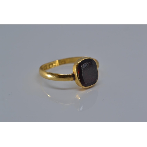 147 - 22ct gold ring with early Victorian hallmark, bezel-set with a red stone, size P, gross weight 2.1 g... 