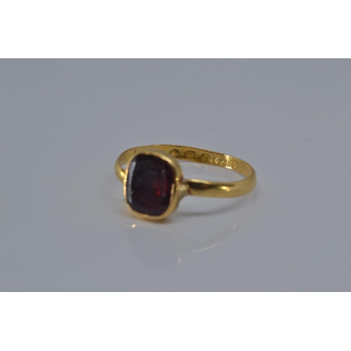 147 - 22ct gold ring with early Victorian hallmark, bezel-set with a red stone, size P, gross weight 2.1 g... 