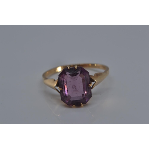 149 - 9ct gold ring with single purple stone, size N/O, gross weight 1.9 grams