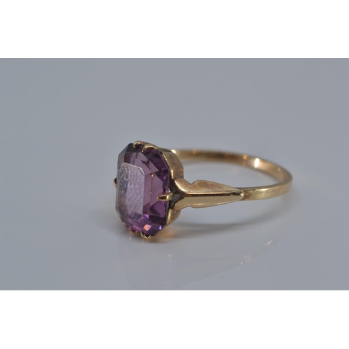 149 - 9ct gold ring with single purple stone, size N/O, gross weight 1.9 grams