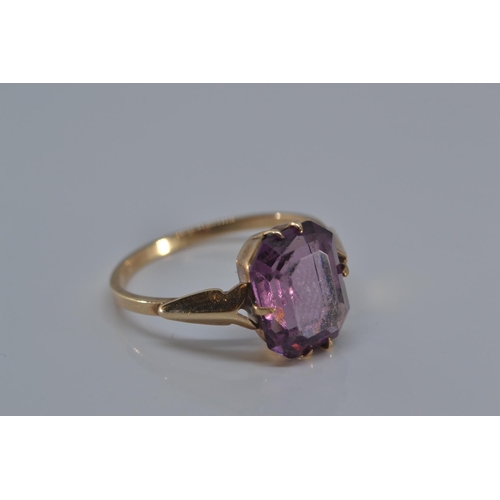 149 - 9ct gold ring with single purple stone, size N/O, gross weight 1.9 grams