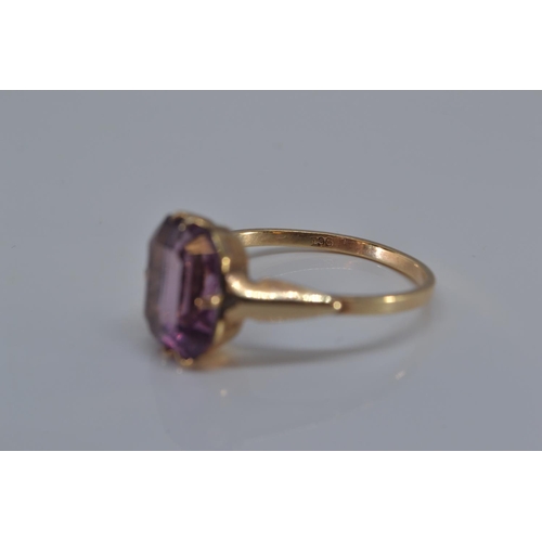 149 - 9ct gold ring with single purple stone, size N/O, gross weight 1.9 grams