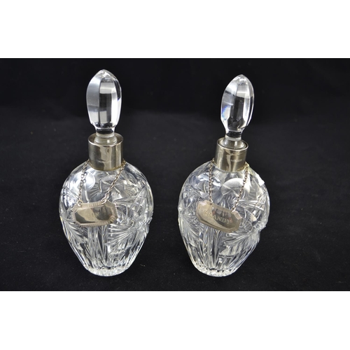 204 - Matched pair of silver collared decanters, with silver decanter labels for brandy & gin, decante... 