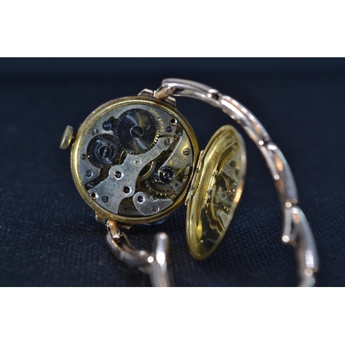 213 - 9ct gold cased & sprung strapped ladies watch, face diameter 26mm, gross weight 18.83 grams