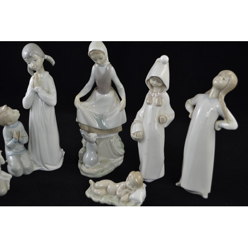 391 - Six Lladro figures inc. two children in nightgowns, shepherd girl, girl with lamb, girl with rabbit ... 