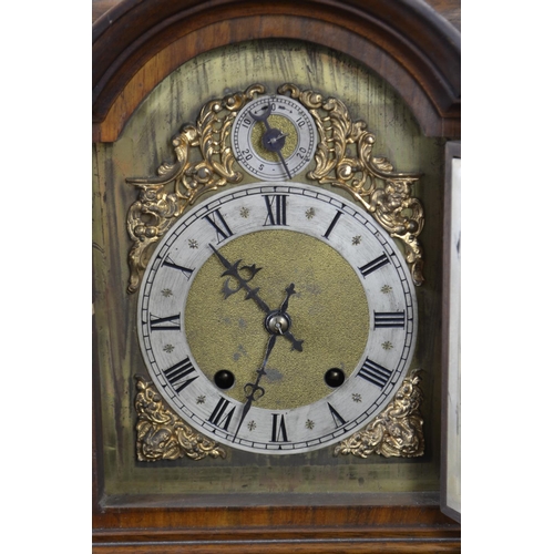 399 - Ornate mantle clock with 2 dials ,gilt decoration around the face, with key and pendulum. Ht 48.5cms