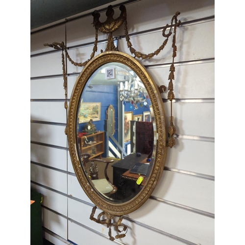 375 - Pair of oval bevelled gilt framed Empire style mirrors, overall W43x H73cm