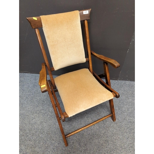 449 - Campaign chair upholstered in camel coloured velvet.