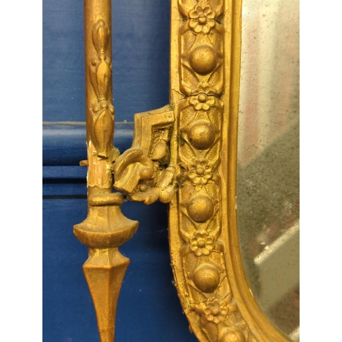 510 - Ornate gilt framed pier mirror. Mirror is silvered with age. H106 x W48cm