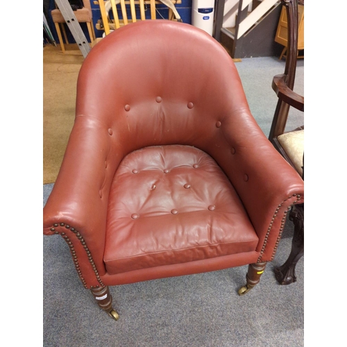 460 - Button back red leather armchair on casters, seat ht 43 cms, full ht 87cms