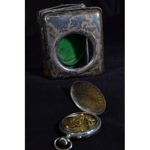 221 - Silver fronted watch stand, hallmarks rubbed, 8.5cm high, enclosing an open faced pocket watch with ... 