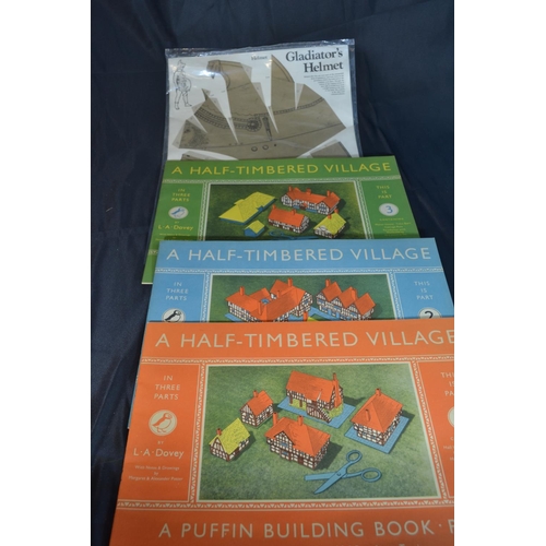 311 - 2 National Trust model bulidings, 3 Puffin building books and a Gladiator Helmet.