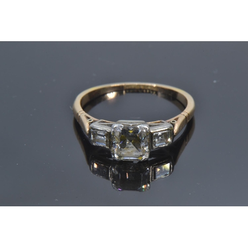 72A - 18ct gold, platinum & emerald-cut diamond trilogy ring, the centre stone weighing approximately ... 