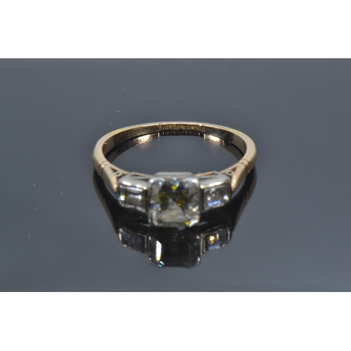 72A - 18ct gold, platinum & emerald-cut diamond trilogy ring, the centre stone weighing approximately ... 