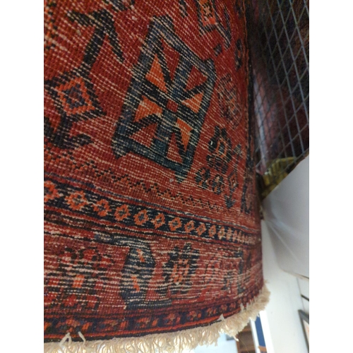 531 - Hand woven wool rug with red ground and navy & burnt orange geometric design. 120cm x 280cm