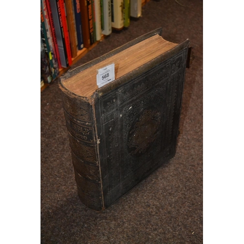 568 - Colour illustrated family bible. Leather bound with gilt detail and brass hinges